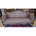 A Louis XV Revival rosewood sofa, shaped back crested by flowers and foliage, scroll hand rests,