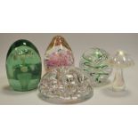 Paperweights - a Victorian green glass dump paperweight double floral inclusion; others, Langham,