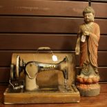 A painted wooden Thai buddha, 58cm high; A Singer hand-crank sewing machine, marked 128K,