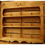 A farmhouse pine wall hanging plate rack,