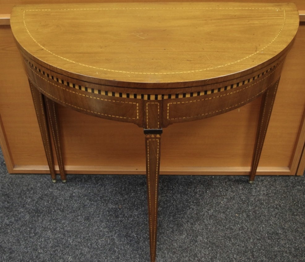 An Edwardian mahogany card table, fold over D top opening to circular green baize playing surface,