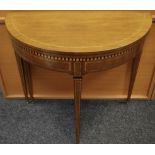 An Edwardian mahogany card table, fold over D top opening to circular green baize playing surface,
