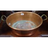 A Victorian copper roll top two handled pan