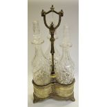 A Victorian plated trefoil decanter stand, with three cut glass decanters,