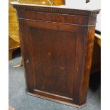 A 19th Century oak corner cupboard, dentil cornice, interior fitted three shaped shelves,