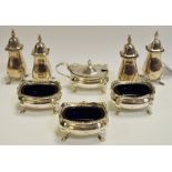 A set three George V silver open salts, raised on four pad feet, blue glass liners,
