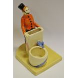 A novelty ceramic cigarette and match holder, as an usher standing,
