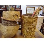 A two handled wicker log bin; a pair of wicker log bins; a wicker stick stand and sticks;