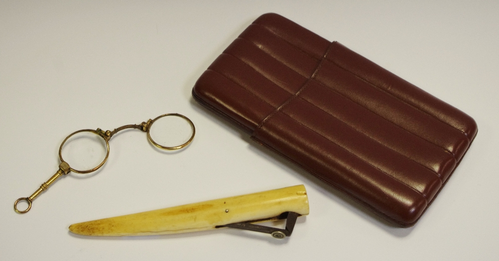 A 19th century marine ivory cigar cutter; a pair of gold plated folding lorgnette,