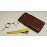 A 19th century marine ivory cigar cutter; a pair of gold plated folding lorgnette,