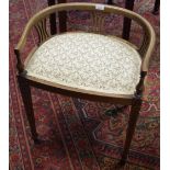 An Edwardian mahogany piano stool, low horseshoe rail pierced splat, padded seat, tapered legs,