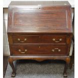 An early 20th century mahogany bureau, ball and claw feet, c.