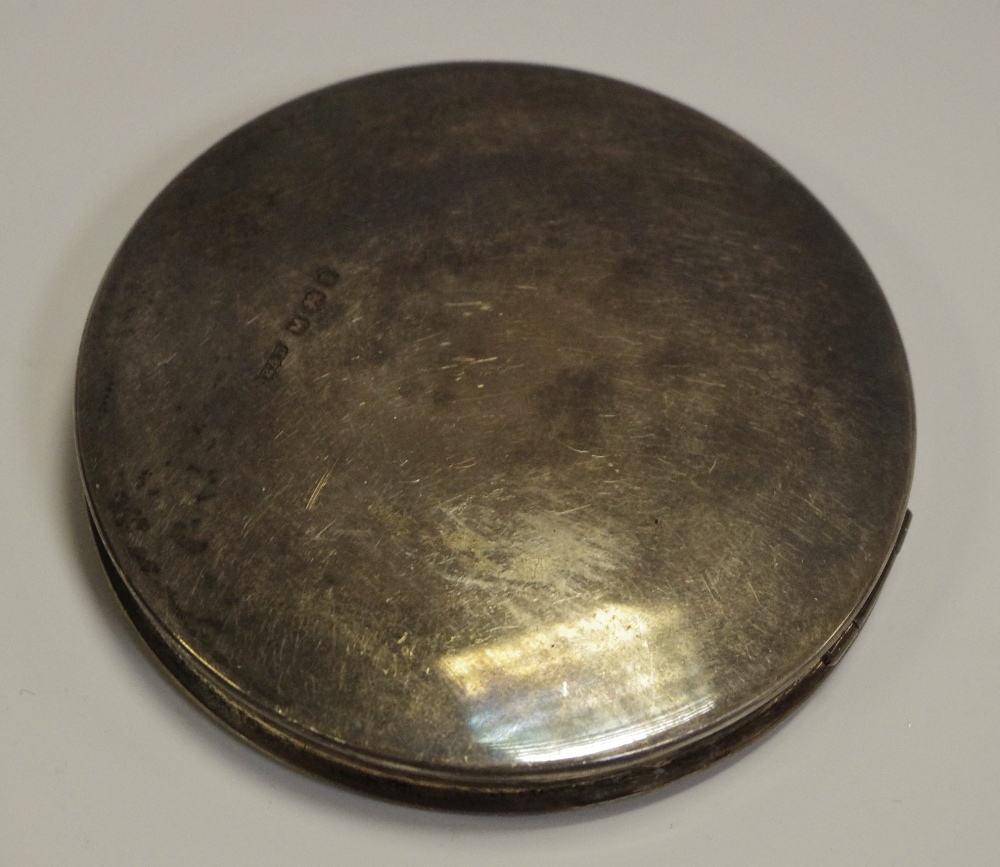 A George VI silver circular compact, of substantial gauge,