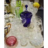A cut glass pedestal vase; a Bristol Blue type slice cut pedestal waisted vase and cover;