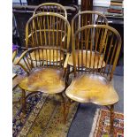 A set of four ash and elm chairs comprising of Windsor type carvers and dining chairs,