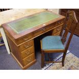 An early 20th century oak twin pedestal desk, green tooled leather writing surface, 107cm wide,