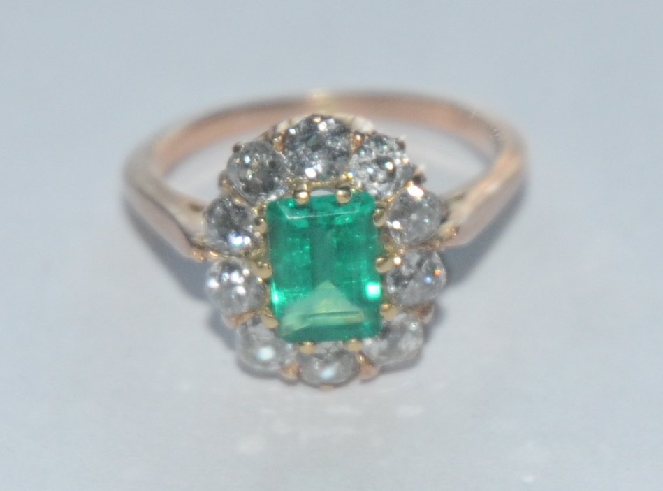 A Colombian emerald and diamond ring, central certified octagonal vibrant green Colombian emerald,