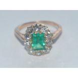 A Colombian emerald and diamond ring, central certified octagonal vibrant green Colombian emerald,