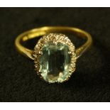 An aquamarine and diamond oval cluster ring ,central oval aquamarine approx 2.