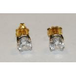 A pair of round brilliant cut diamond stud earrings,