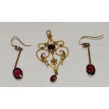 An Art Nouveau 9ct gold garnet and seed pearl set pendant,