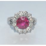 A synthetic vibrant red ruby and mossanite/diamond cluster ring,