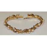 An 18ct gold diamond and cultured pearl fancy link bracelet,