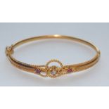 An Edwardian style white sapphire and red spinel hinge bangle,