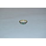 An emerald green stone and white sapphire trilogy ring, 18ct gold shank, Birmingham 1983, size K,