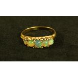 An Edwardian style opal and diamond line ring, five graduated foil back green cabochon opals,