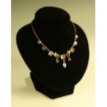 An opaline quartz and red spinel fringe necklace, tapering body of seven square cabochons,