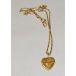 A 14ct gold heart locket pendant, suspended from an 18ct gold fancy link chain necklace, 6.