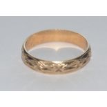 A 9ct gold textured band ring, London 1987, size L, 1.