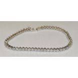 A diamond tennis bracelet, linear set with fifty seven round brilliant cut diamonds,