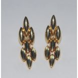 Cartier - a pair of retro 1980s 18ct gold scale drop earrings, each composed of seven navette links,