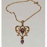 A Victorian 9ct gold drop pendant in the shape of heart set with an oval amethyst and a heart