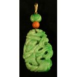 A carved green jade tablet pendant, as a dragon and fish entwined,