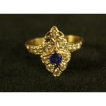 An Art Deco style shield fan ring, inset with a single oval vibrant blue sapphire approx 0.