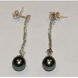 A pair of 18ct white gold Tahitian cultured black pearl and diamond drop earring,