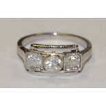 A diamond trilogy ring, linear set with three old brilliant cut diamonds,