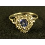 A sapphire and diamond heart cluster ring, central oval pale blue sapphire approx 0.
