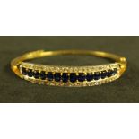 A sapphire and diamond hinge bangle,