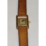 A 'Must de Cartier' by Cartier lady's 'Tank' wristwatch, silvered dial, gold plated silver case,