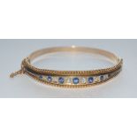 A sapphire and diamond hinge bangle,