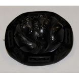 A large Whitby Jet brooch carved in relief of an acorn and oak leaves