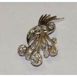 A platinum and diamond bouquet of flowers brooch, encrusted with twelve individually inset diamonds,