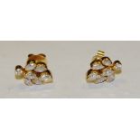 A pair of diamond inset leaf cluster earrings,