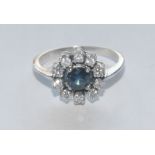 A sapphire and diamond cluster ring, central mid blue round cut sapphire approx 0.