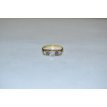 A diamond and amethyst quintet line ring, central old brilliant cut oval diamond approx 0.