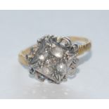 A 19th century diamond cluster ring, square crest inset with five cushion and rose cut diamonds,